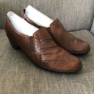 Brown Clark’s low heel shoes.